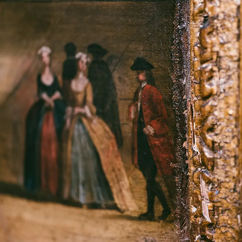A vintage typewriter placed on a red couch. Next to the typewriter, there is a brown leather handbag on a white table. There is also a piece of paper with some printed text and drawings.